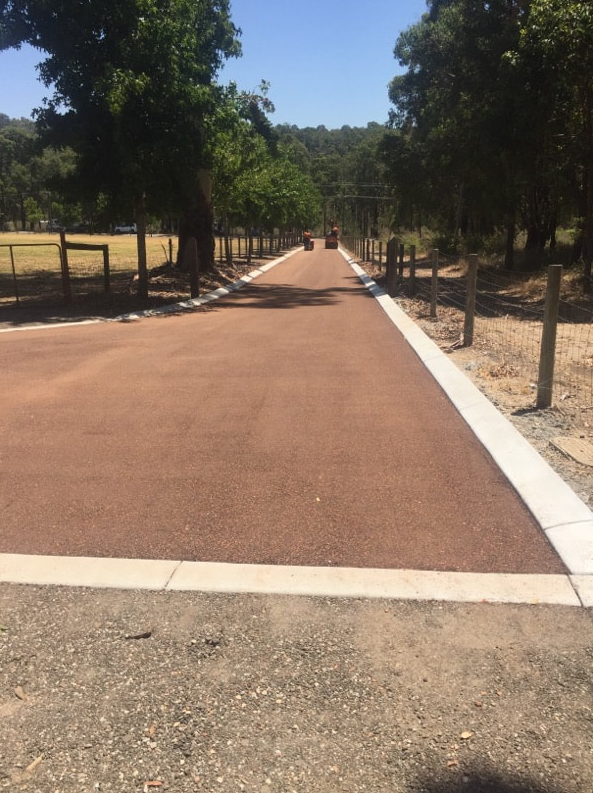 This is a photo of a hot spray & seal bitumen roadway which is in the process of being installed by Heatherton Road Tech